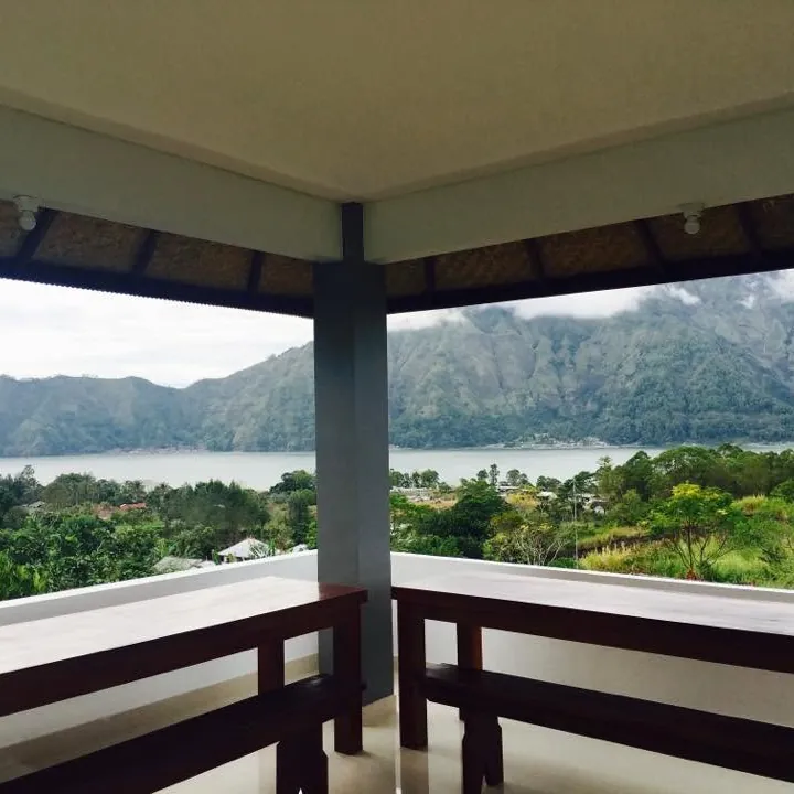 Covered balcony with wooden benches overlooking Lake Batur