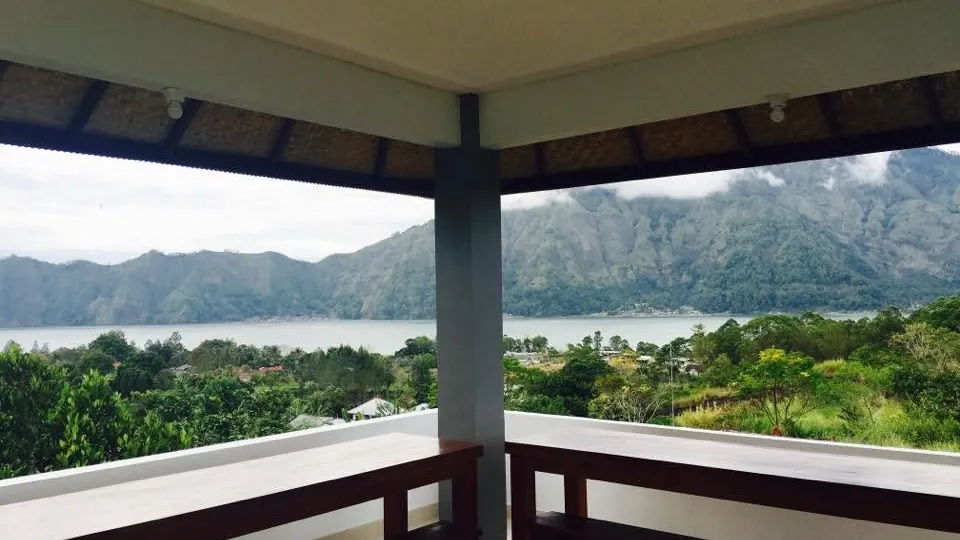 View from a covered balcony at the guest house towards Lake Batur and the caldera wall