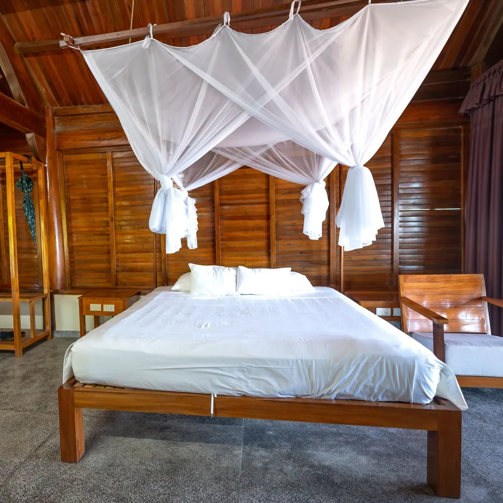 Illustrative photo of a wooden bedroom with a canopy bed