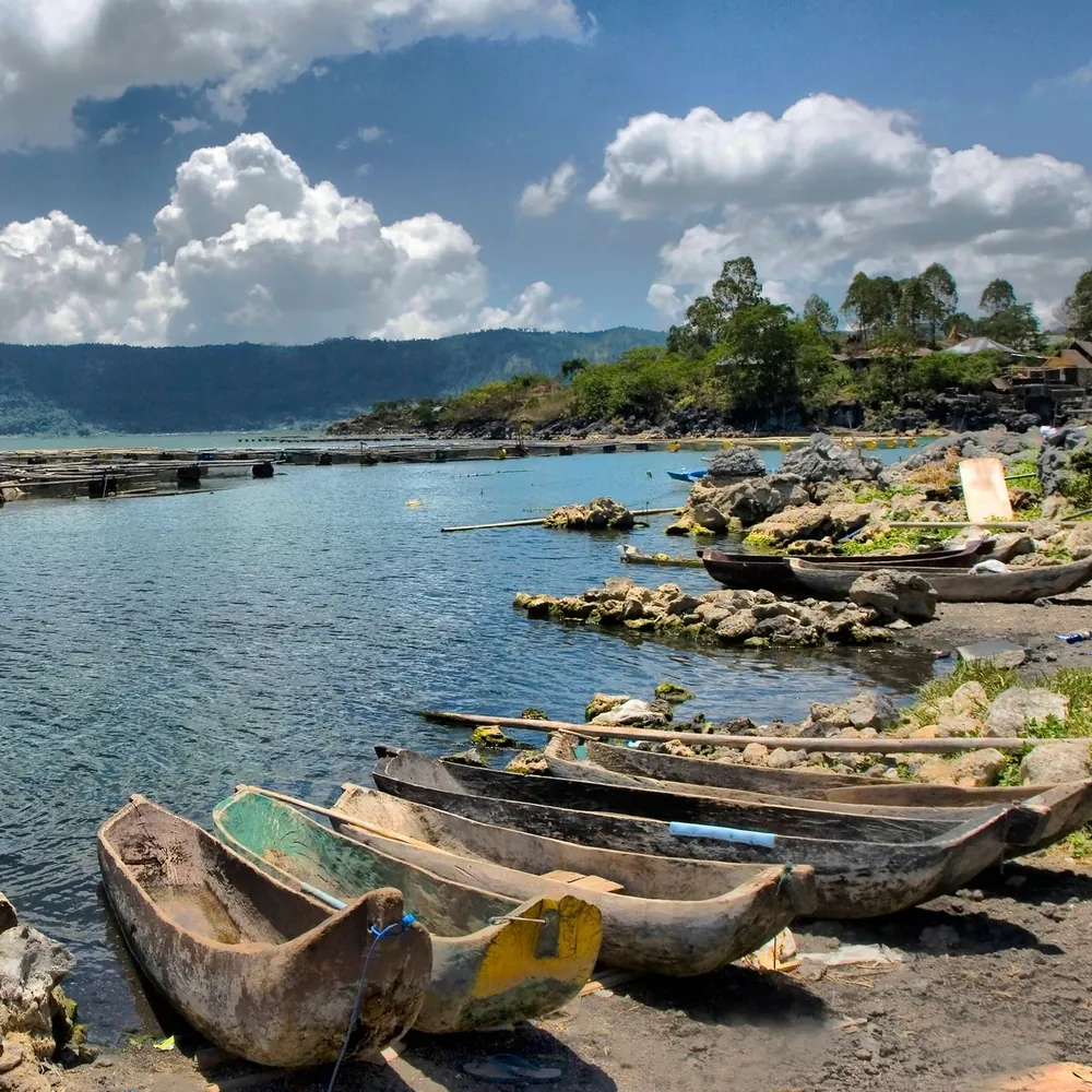 Illustrative photo of wooden canoes on the shore of Lake Batur