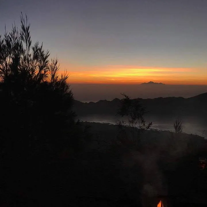 Before dawn on Mount Batur, with the first orange light on the horizon