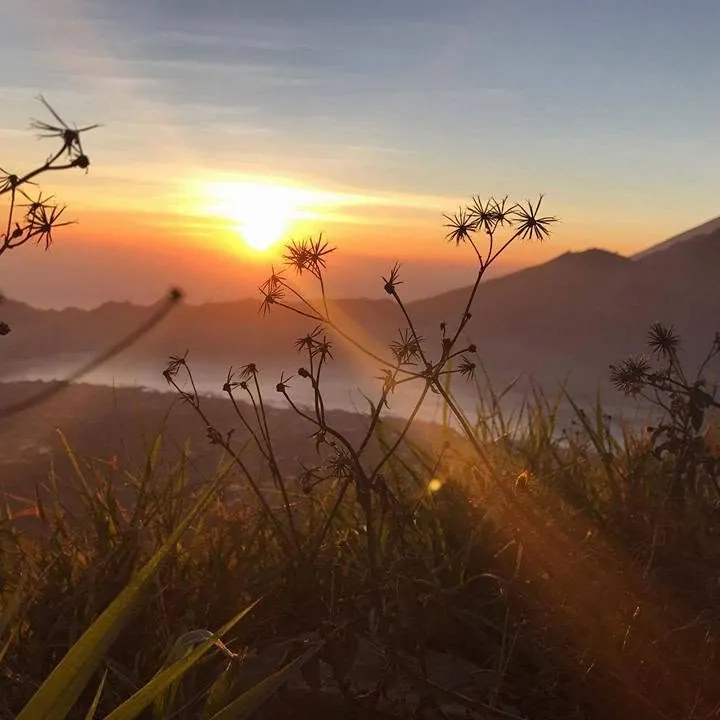 The sun rising over the hills, seen from the slopes of Mount Batur